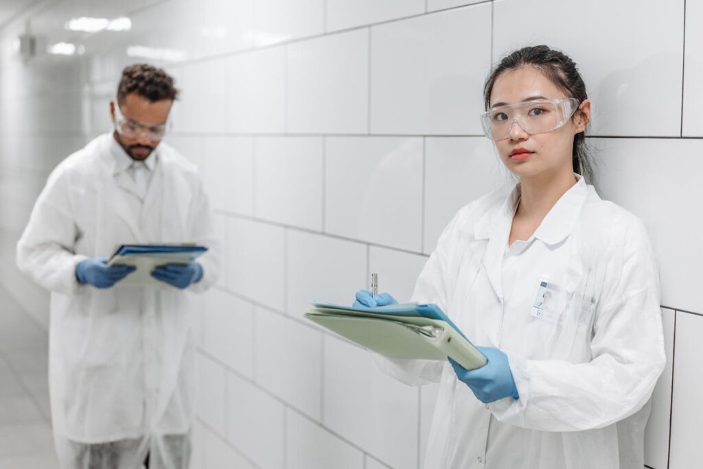 Woman in White Button Up Shirt Holding Green Tablet Computer