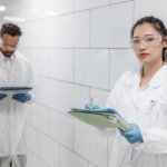 Woman in White Button Up Shirt Holding Green Tablet Computer